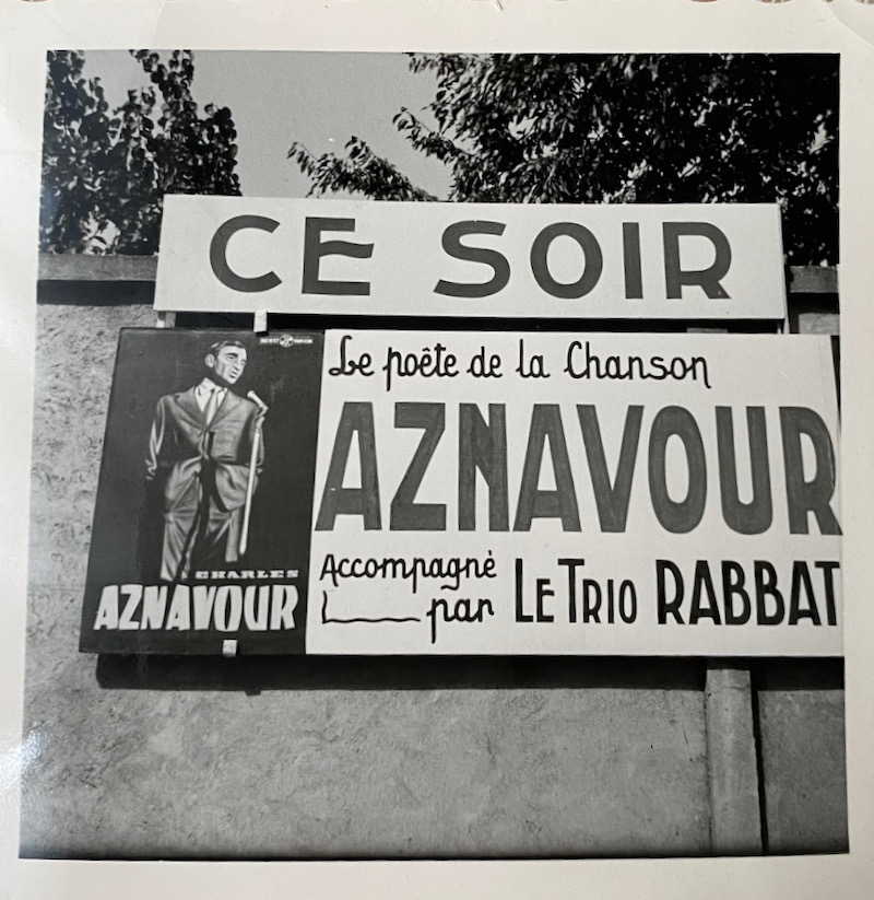 Sign announcing Aznavour in Beirut accompanied by 'Le Trio Rabbat'